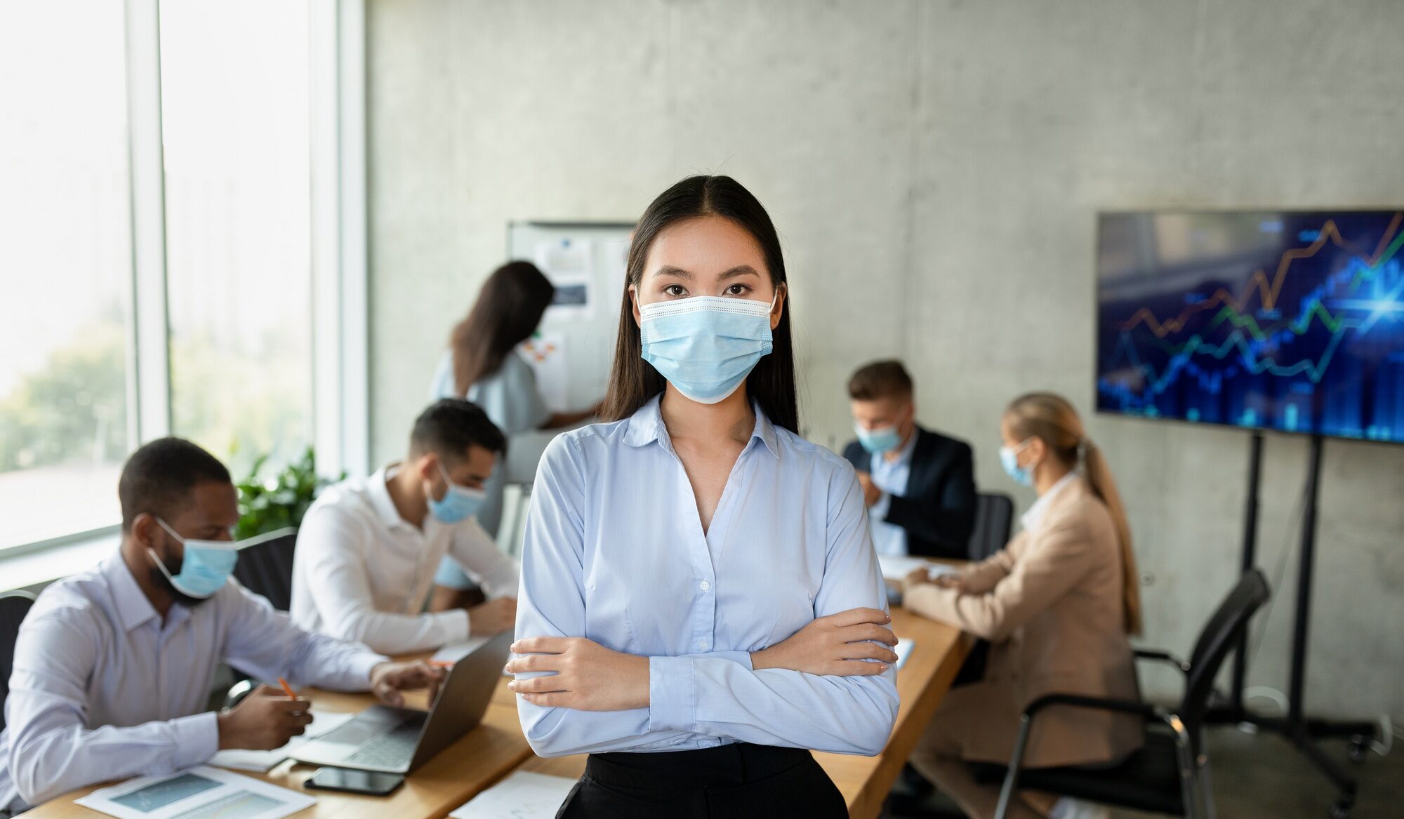 Covid-19 And Entrepreneurship. Portrait of confident young asian businesswoman in medical mask