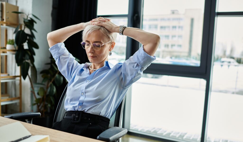Overwhelmed businesswoman contemplating midlife challenges